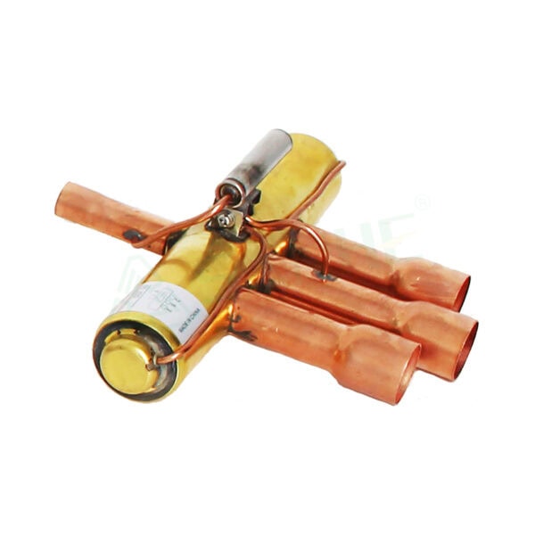 Close-up of a HVAC compressor component with copper pipes and electrical connections, used in heating, ventilation, and air conditioning systems.